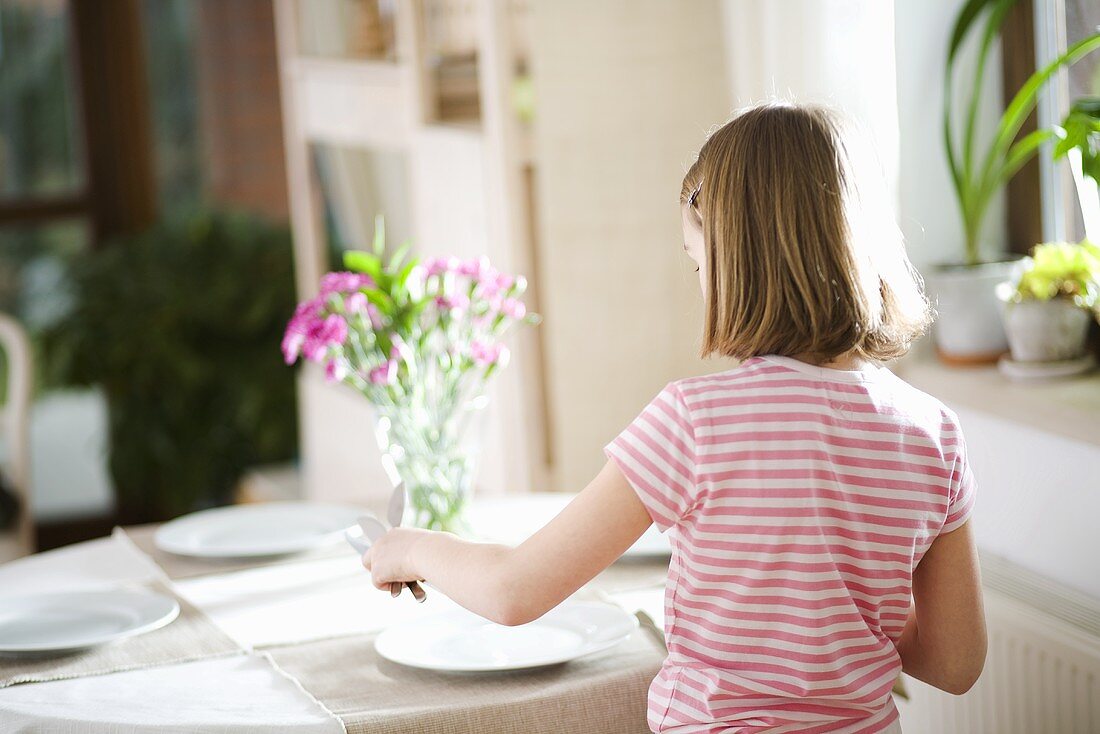 Girl laying the table