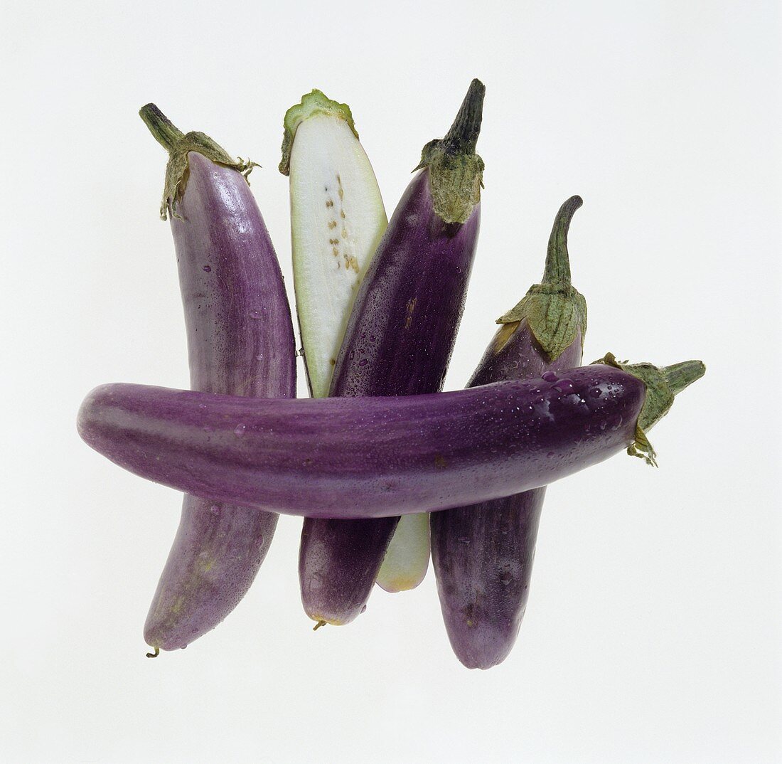 Aubergines, whole and halved