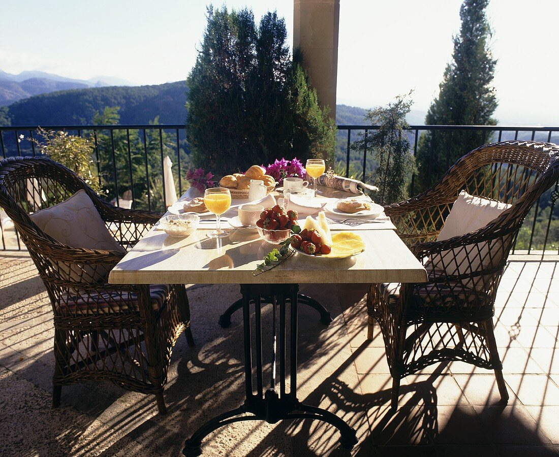 Table laid for breakfast on a terrace