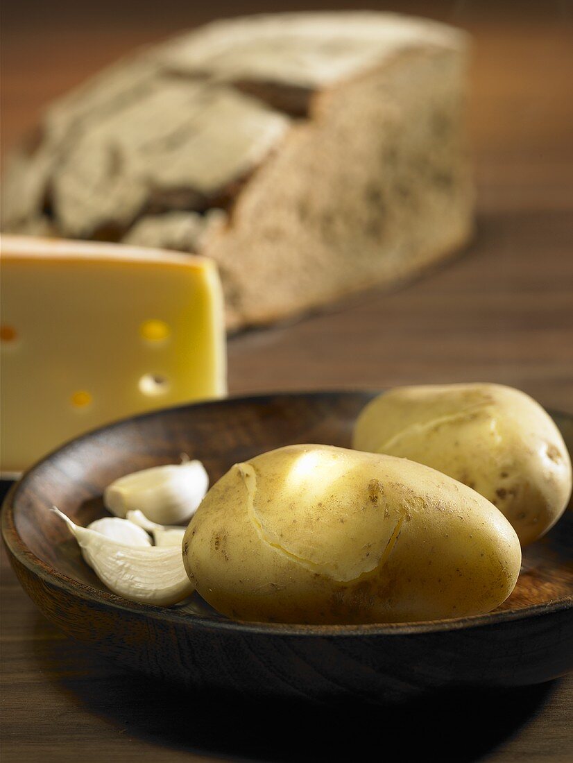 Ingredients for raclette: potato, garlic and cheese