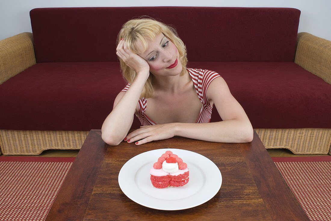 Blond woman with heart-shaped dessert