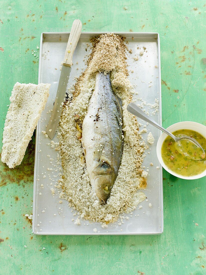 Sea bass in salt crust with olive oil coulis