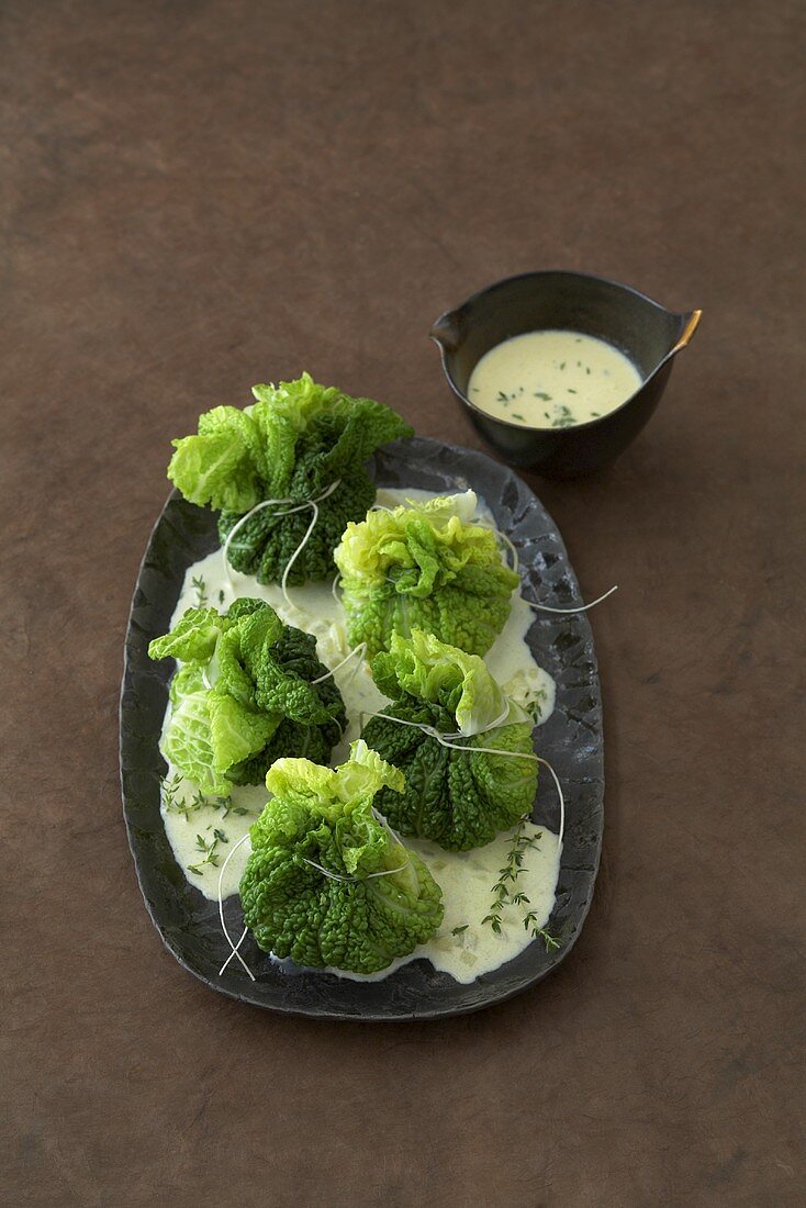 Savoy cabbage purses with polenta filling & onion cream sauce