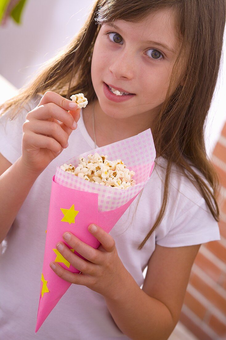 Girl eating popcorn