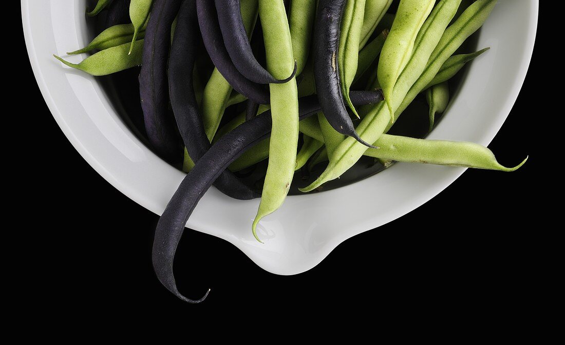 Purple and green beans in a bowl