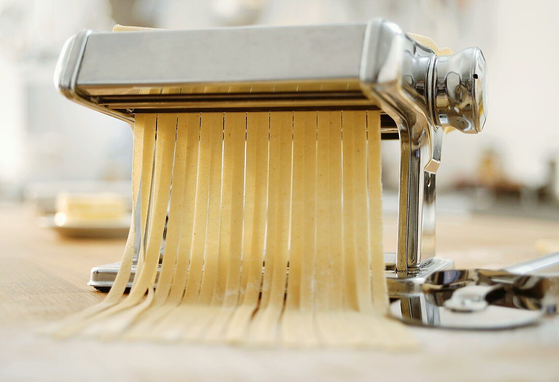 Pasta maker cutting ribbon pasta