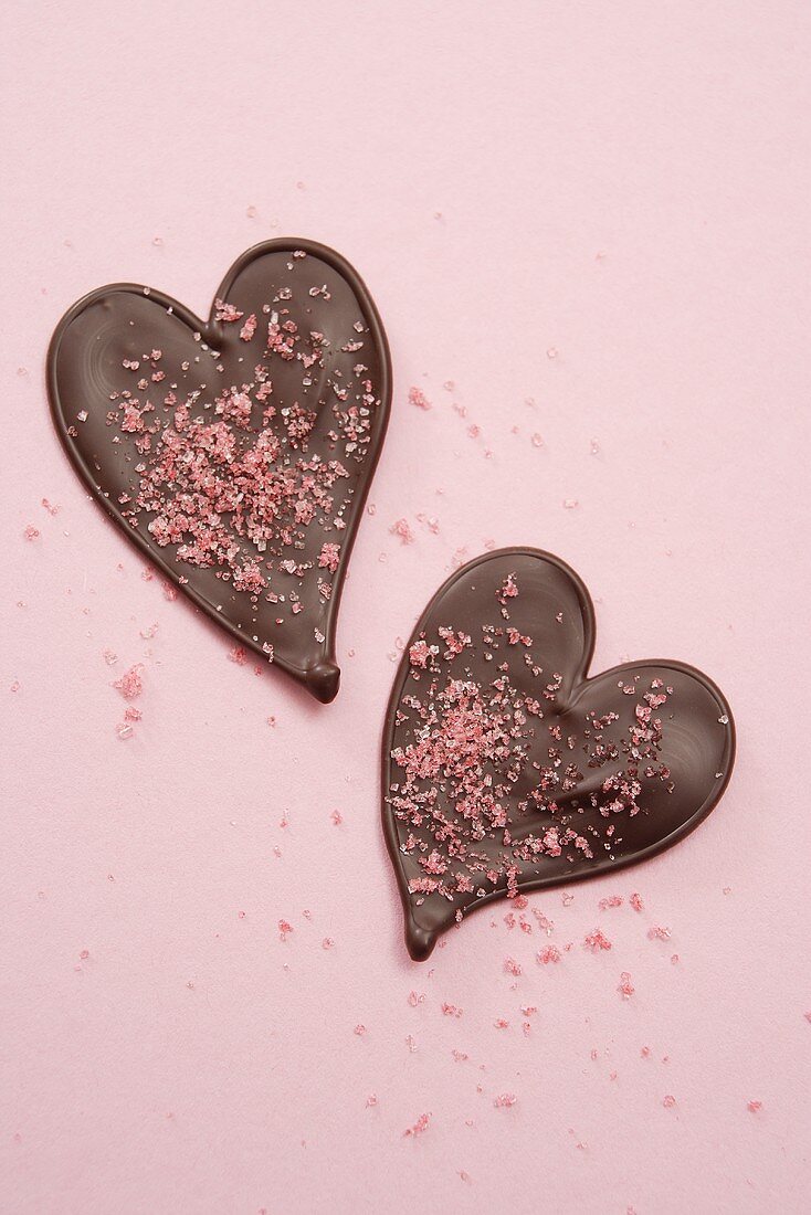 Two chocolate hearts with pink sugar