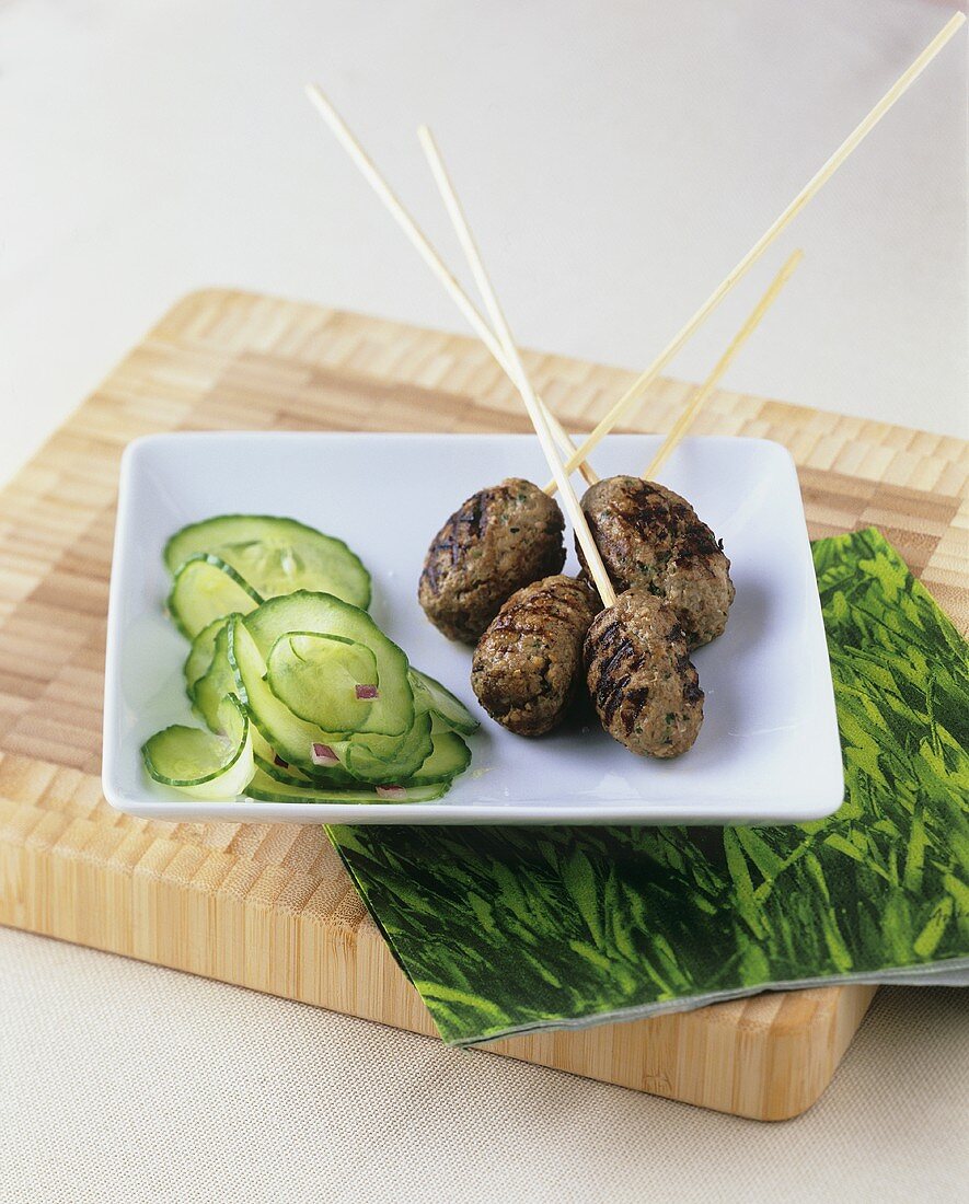Minced lamb on skewers and cucumber salad