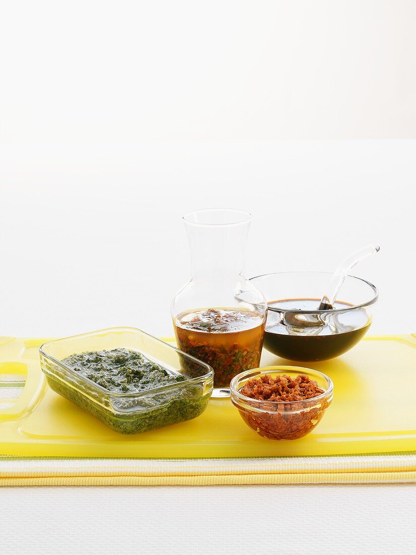 Four different marinades in glass dishes