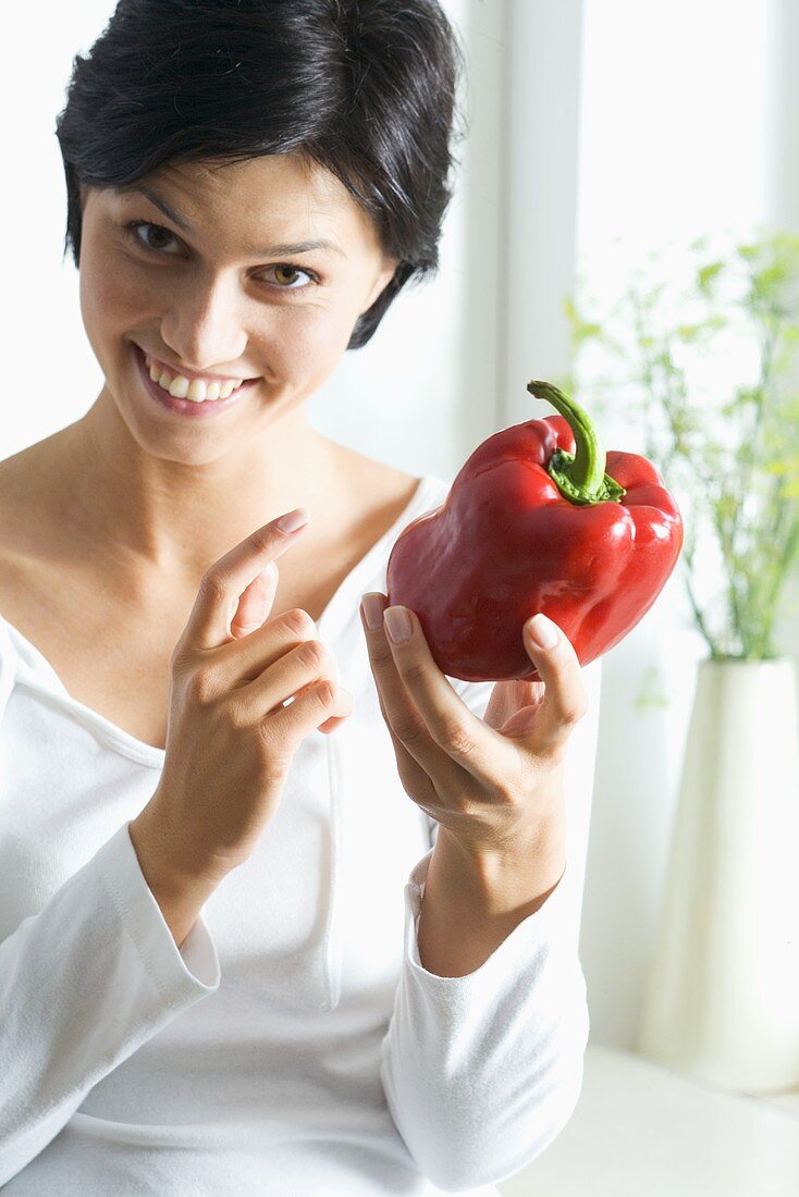 Young woman with a red pepper