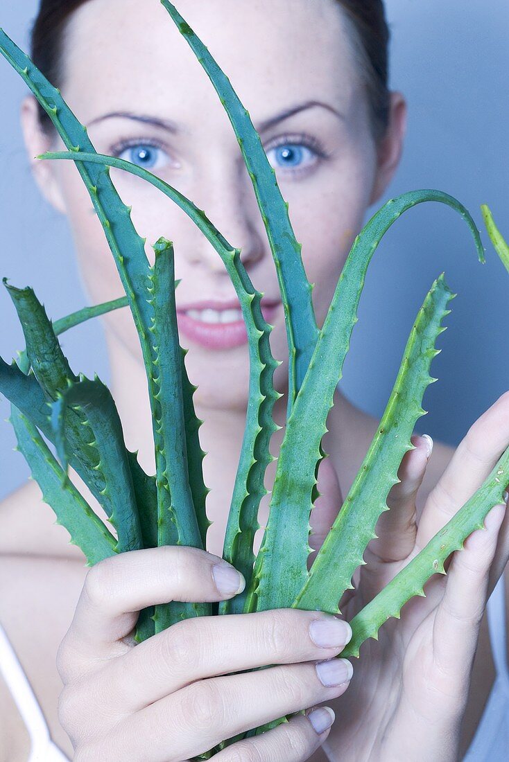 Young woman with Aloe vera