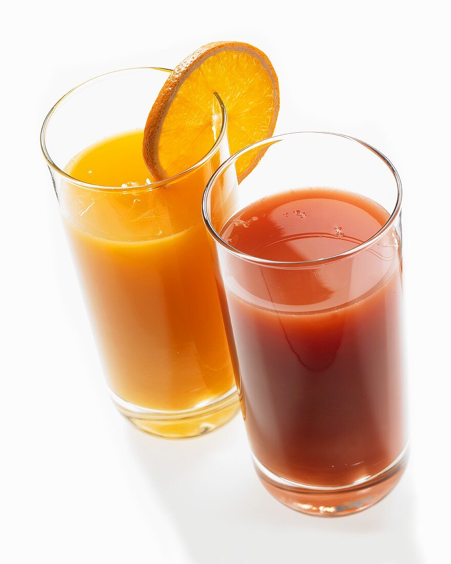 A glass of orange juice and a glass of tomato juice