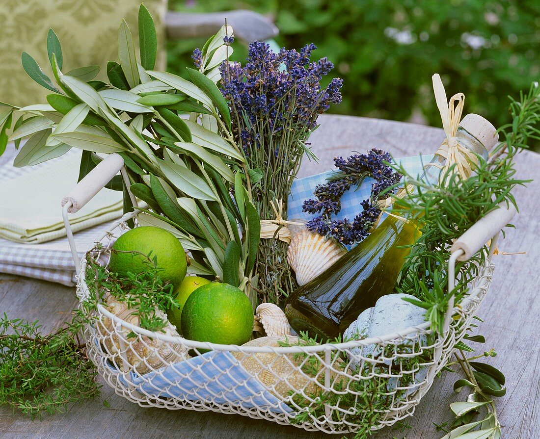 Basket of herbs, olive oil, limes & shells to give as a gift