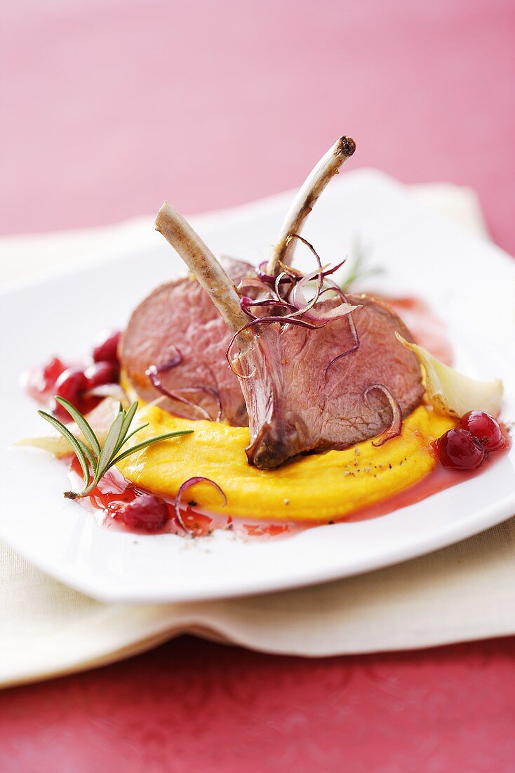 Lamb chops with pumpkin puree and cranberry sauce