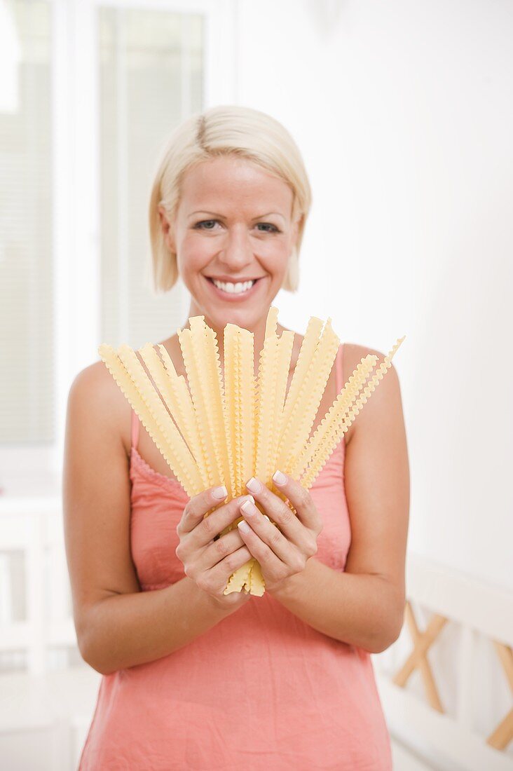 Blond woman with malfadine pasta