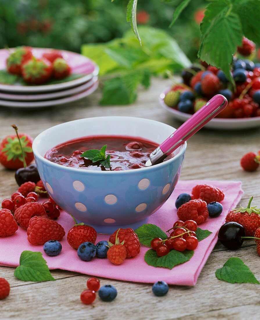 Red fruit compote garnished with fresh berries