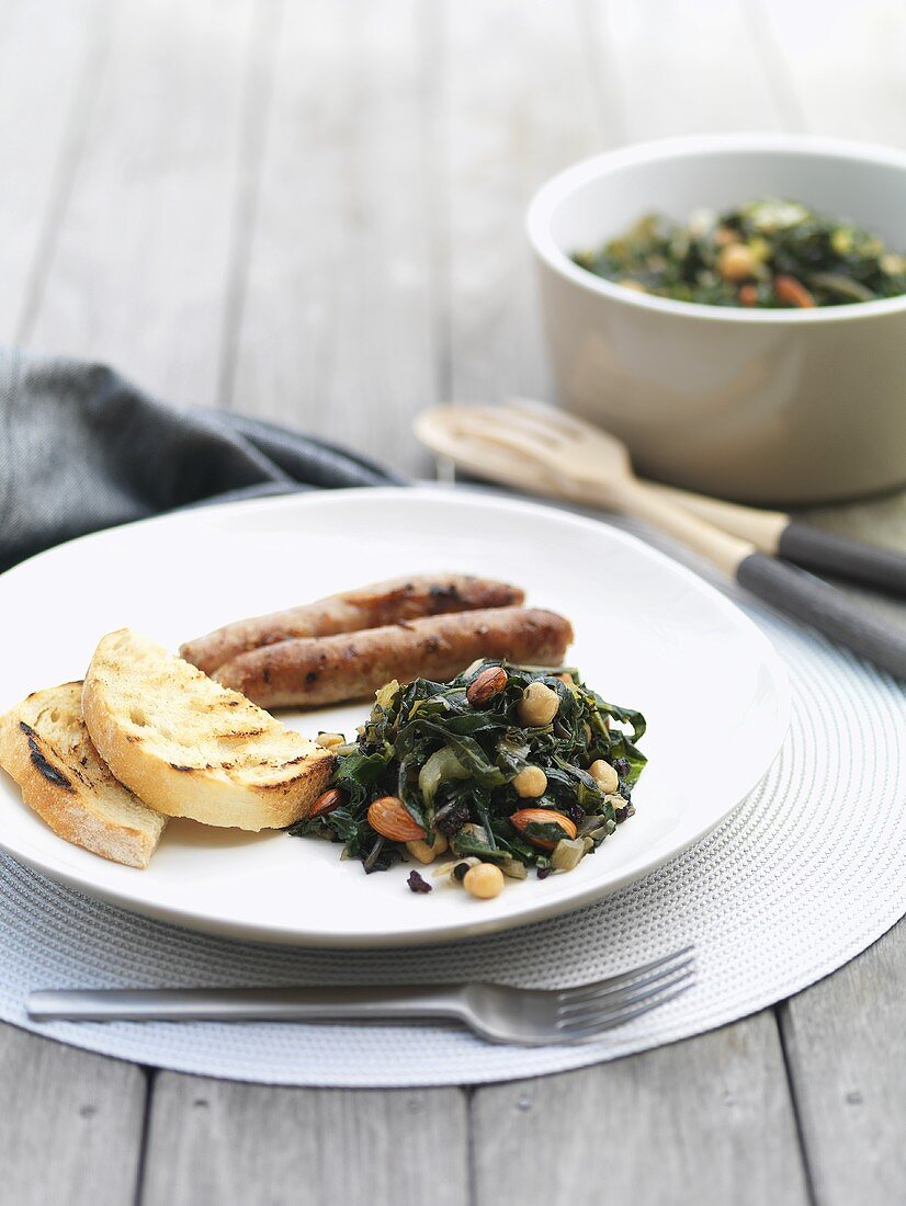 Chard with chick-peas, sausages and grilled bread