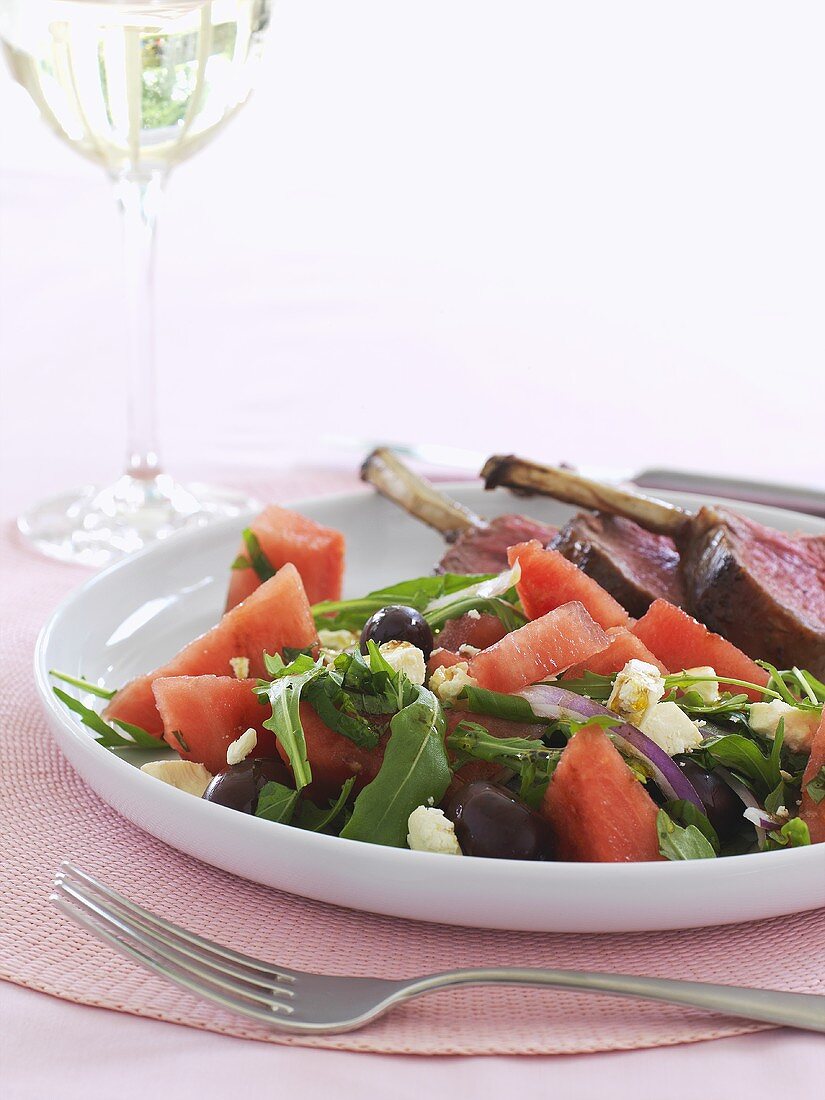 Salad leaves, watermelon and feta with rack of lamb
