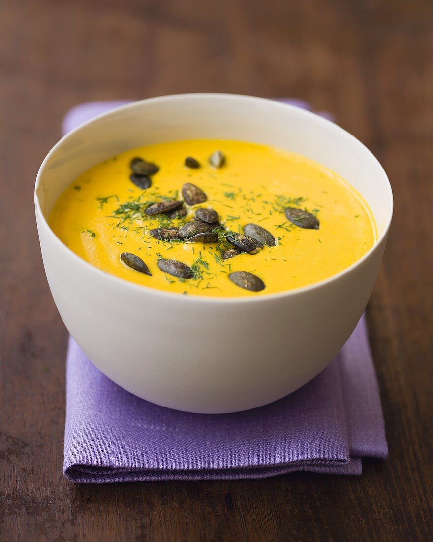 Cream of pumpkin soup with pumpkin seeds and dill