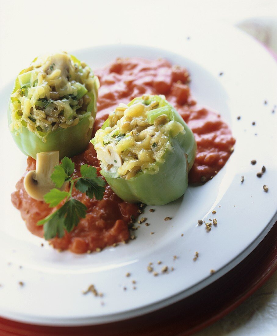 Stuffed green peppers on tomato sauce