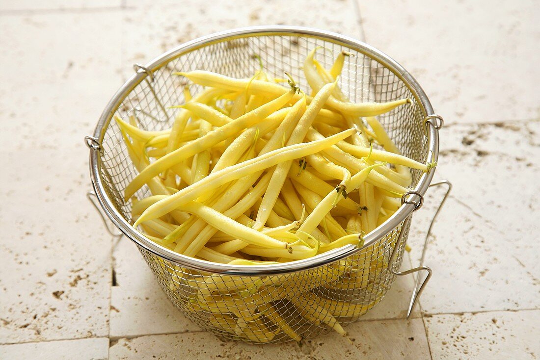 Yellow wax beans in a sieve