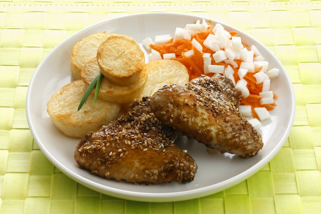 Chicken wings with sesame seeds, potatoes and carrot salad