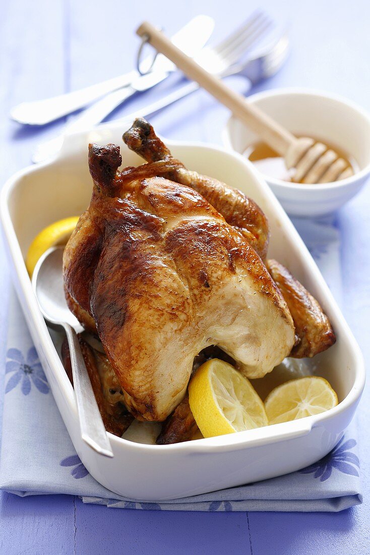 Whole roast chicken with lemon slices