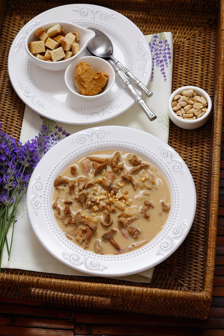 Chanterelle soup with croutons and peanuts