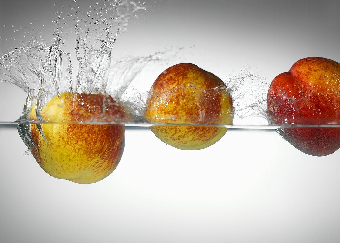 Nectarines falling into water