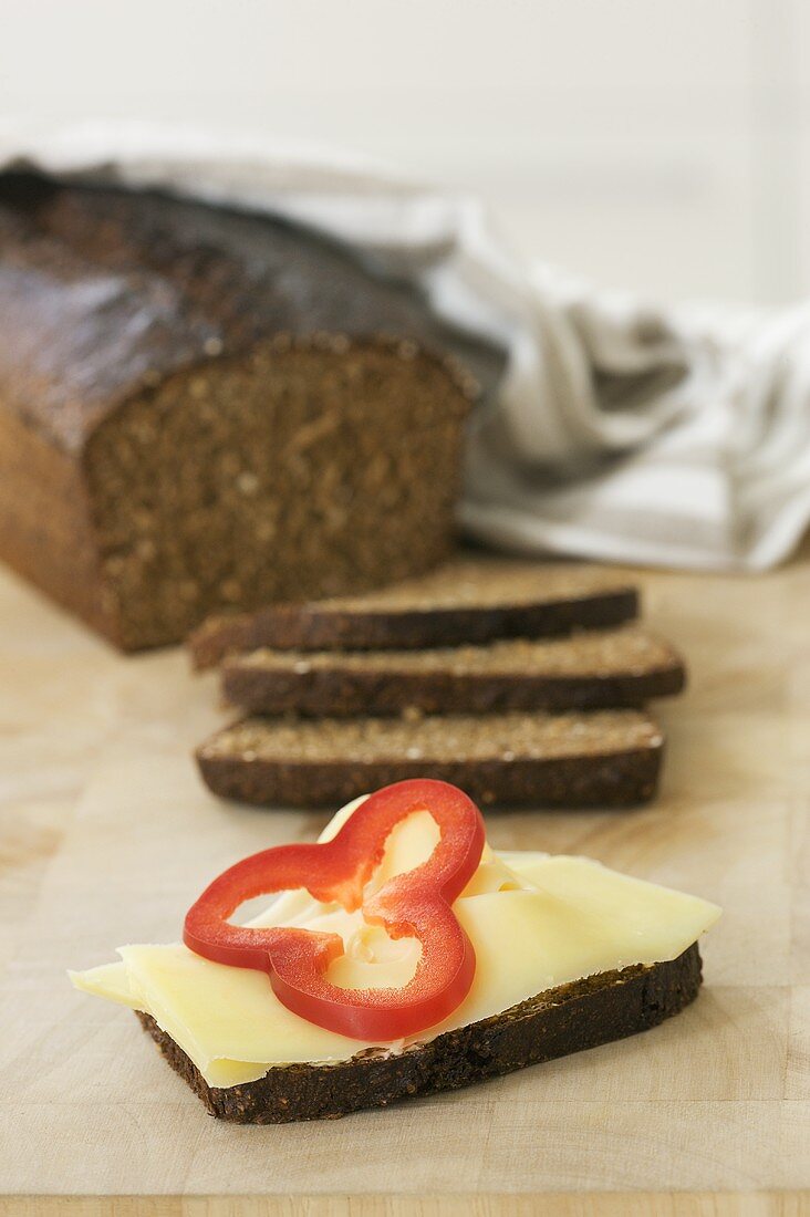 Black bread with cheese and red pepper
