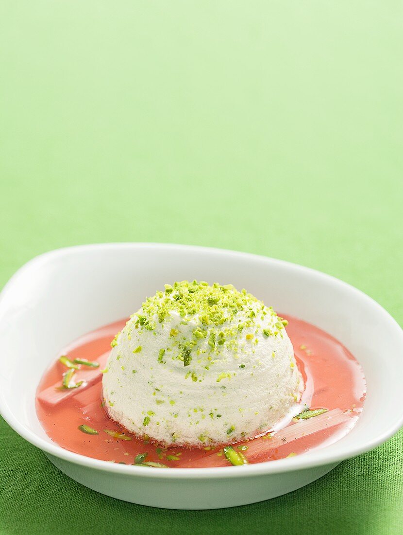 Meringue with pistachios on rhubarb sauce