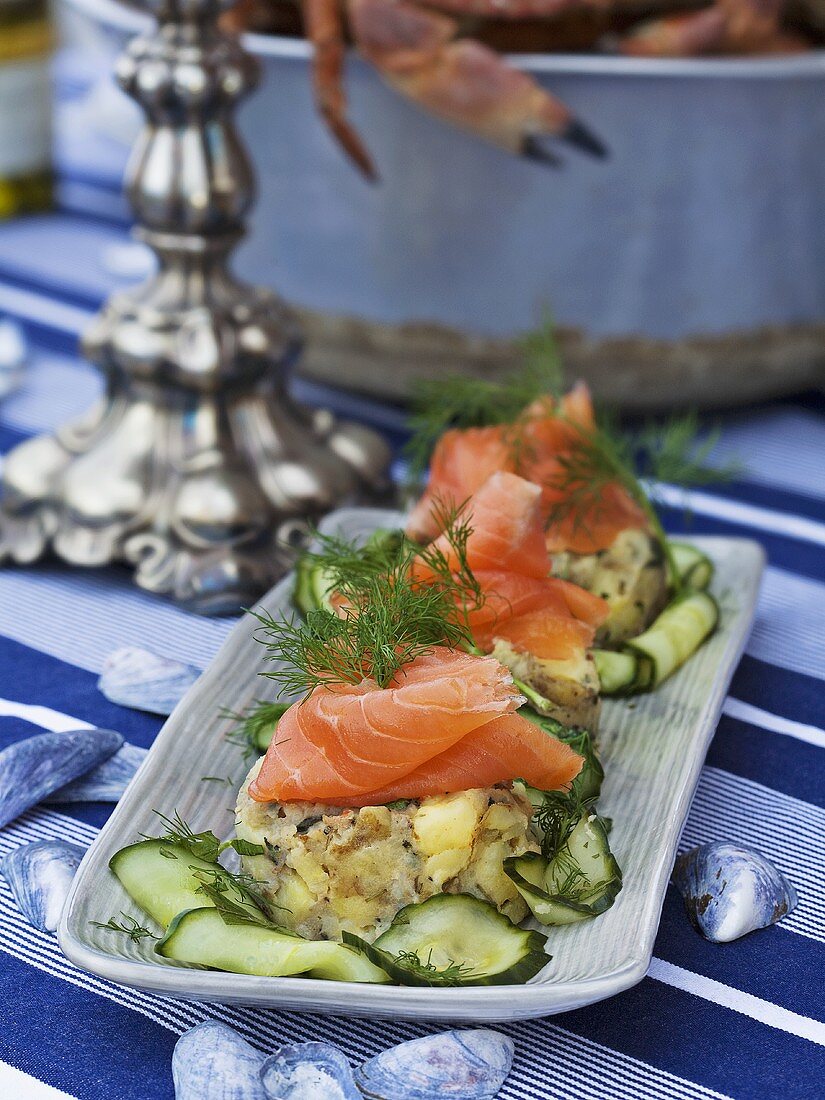 Crab and potato cakes with salmon and cucumber