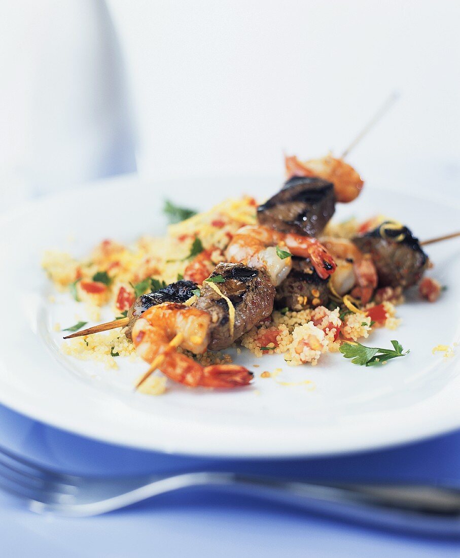 Beef and prawn kebabs on couscous