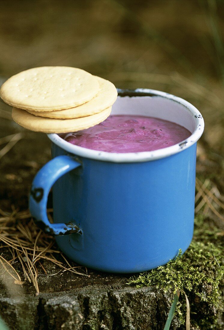 Mug of blueberry shake and biscuits