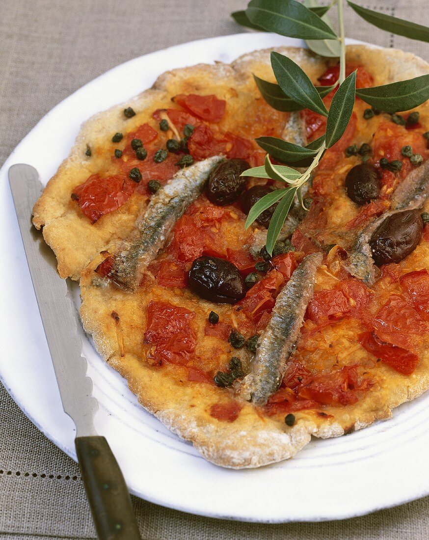 Pizza ligure (Pizza topped with anchovies, capers & olives, Italy)