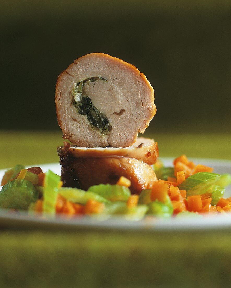 Rolled veal roast on carrots and celery