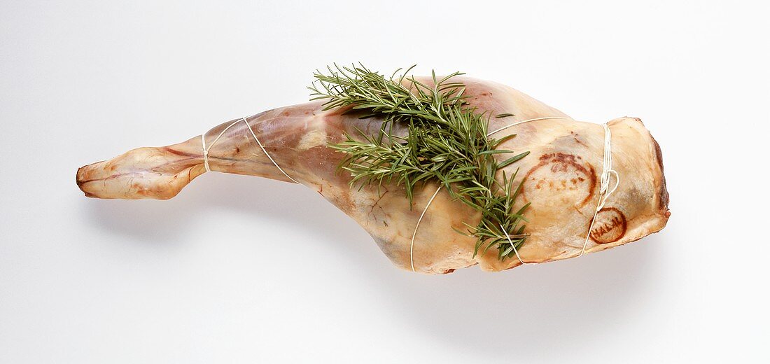 Raw leg of lamb with rosemary