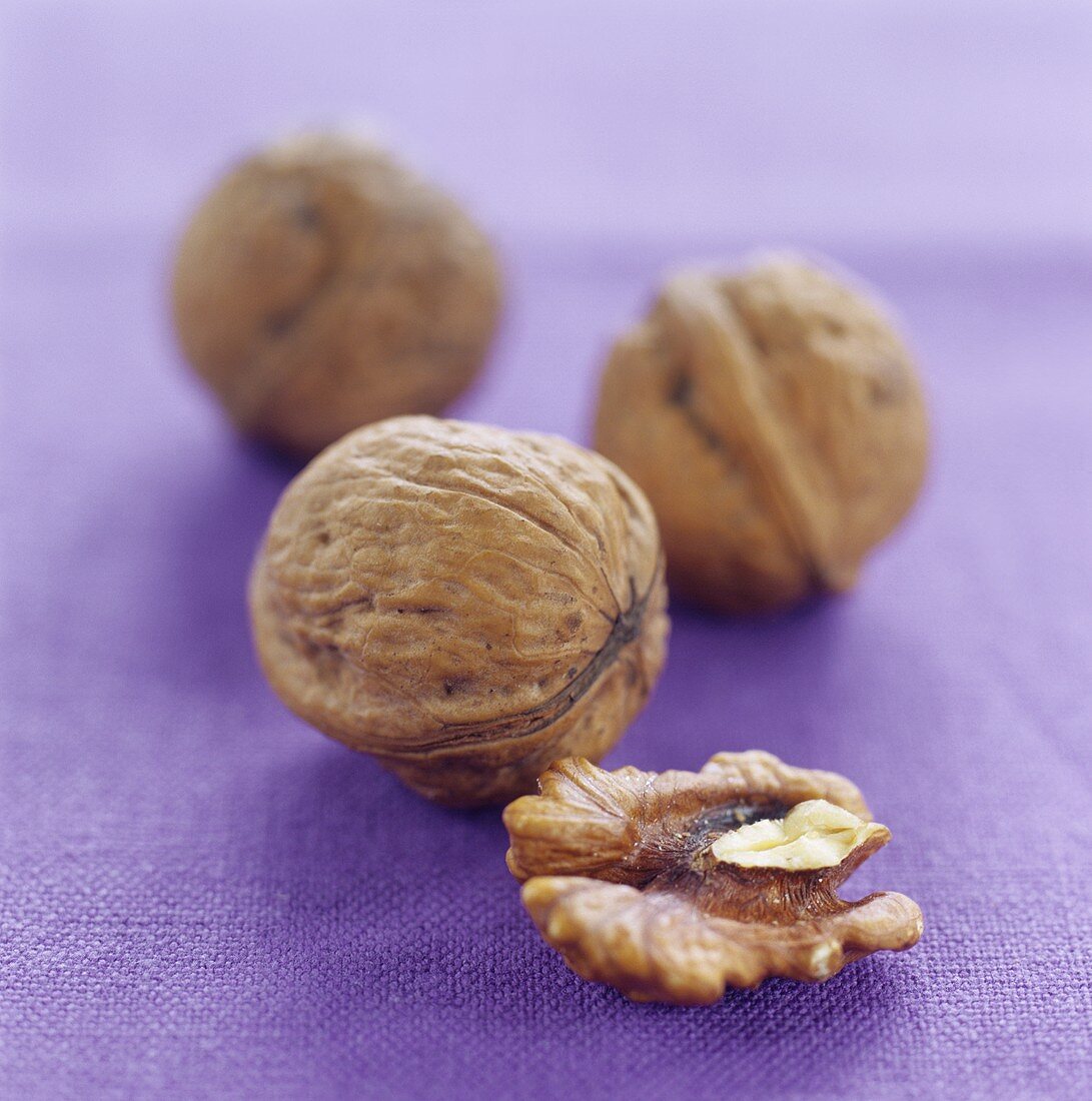 Walnuts on purple background