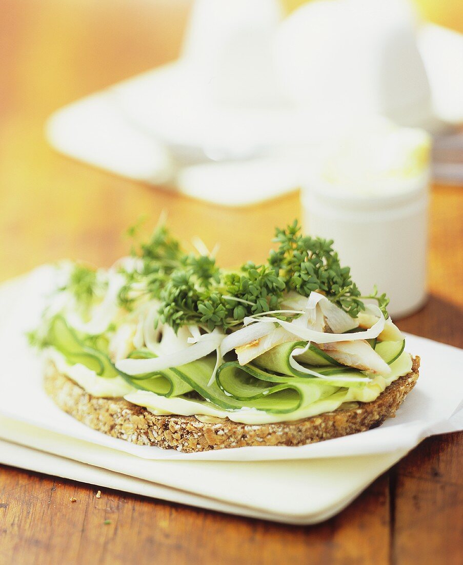 Smoked fish, cucumber slices and cress on wholegrain bread