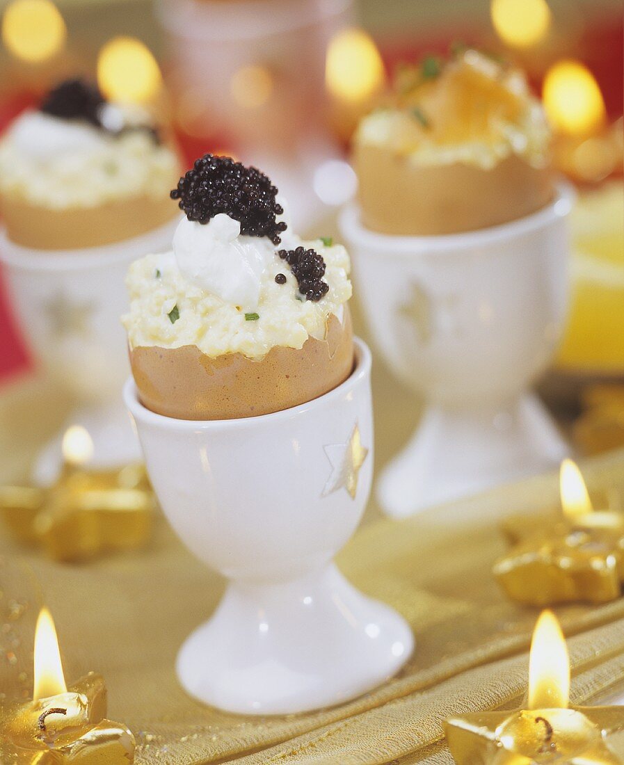 Scrambled egg with caviar in eggshells for Christmas