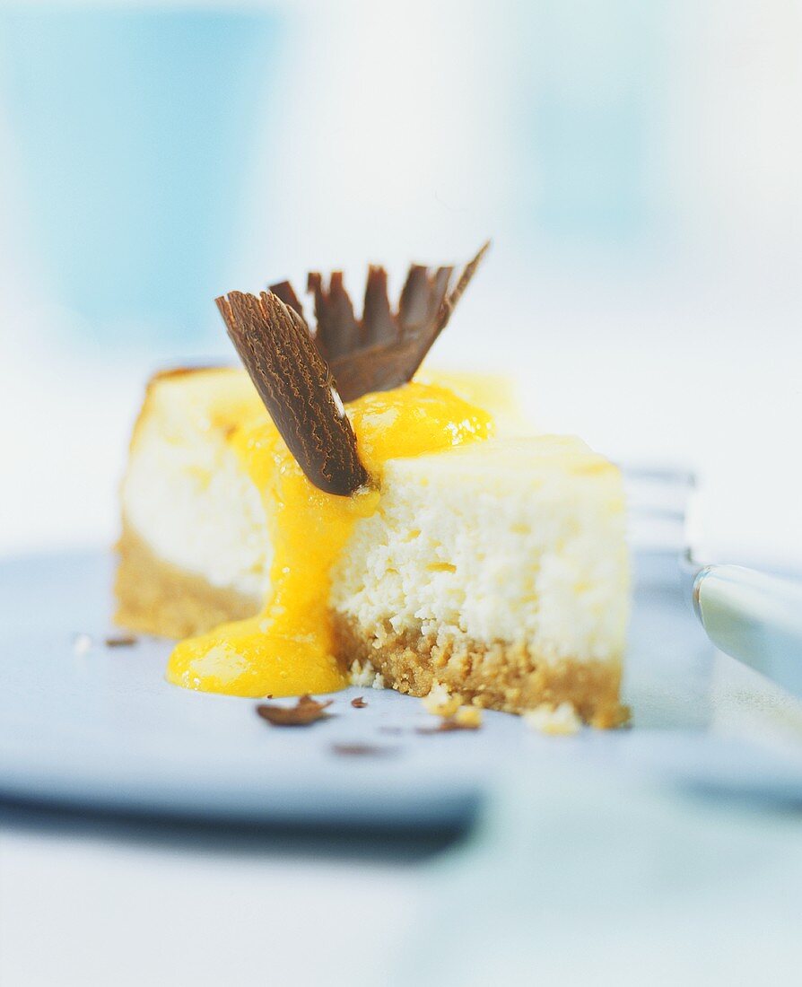 A piece of cheesecake with mango sauce