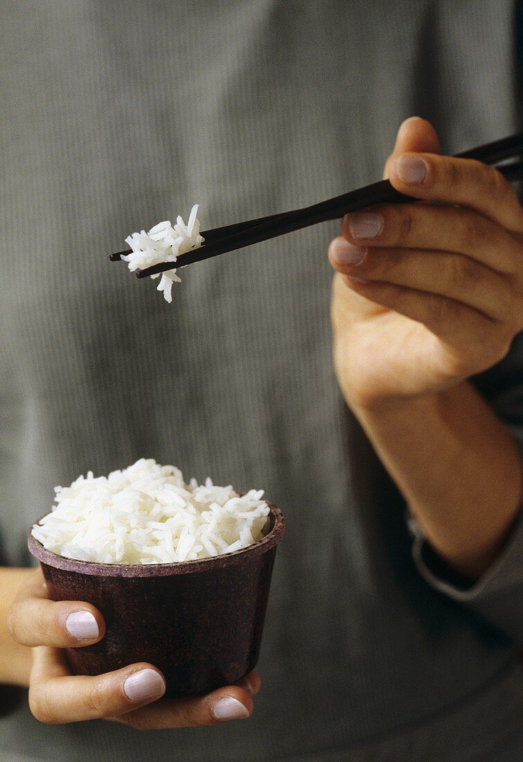 Eating rice with chopsticks