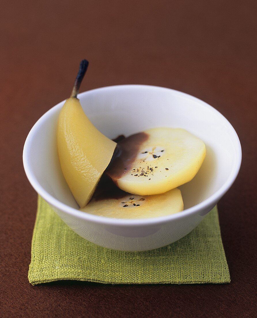 Poached pear with chocolate sauce and pepper