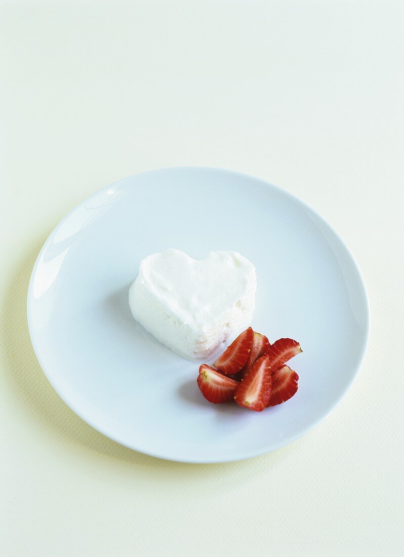 Heart-shaped cream with strawberries