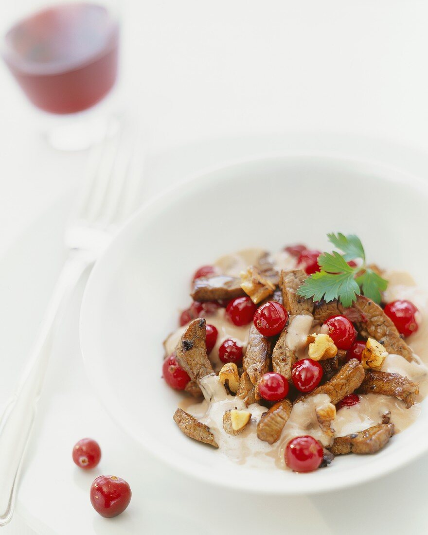 Venison with walnuts and cranberry sauce