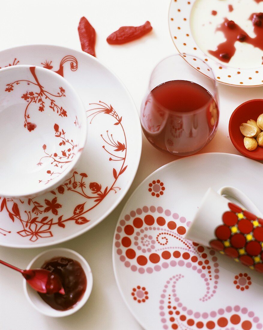 Red and white place-setting with pomegranate juice