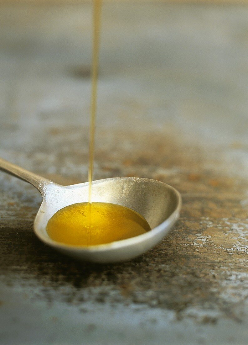 Olive oil running onto spoon