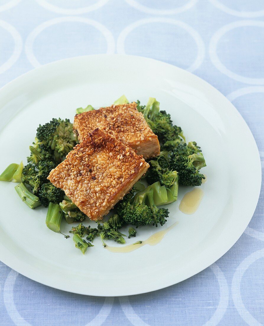 Tofu slices with sesame crust on broccoli