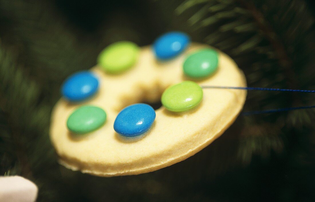 Biscuit with coloured chocolate beans to hang on the tree
