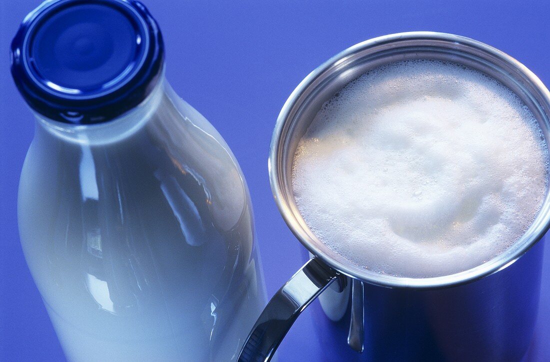 A bottle of milk and frothed milk